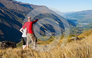 Couple Looking Afar Where The Mountain Lake Concept