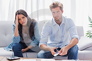 Couple looking anxious while doing their accounts