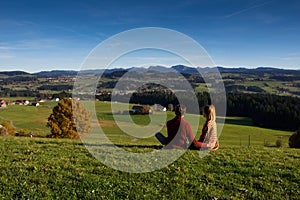 Couple looking at beautiful autumn landscape from Bavaria Germany