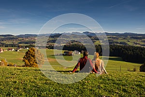 Couple looking at beautiful autumn landscape from Bavaria Germany