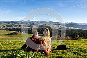 Couple looking at beautiful autumn landscape from Bavaria Germany