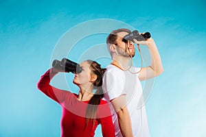 Couple looking through binoculars