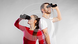 Couple looking through binoculars