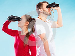 Couple looking through binoculars