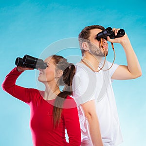 Couple looking through binoculars