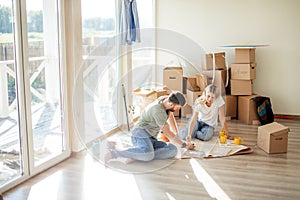 Couple looking blueprints of they new house. Planning interior design