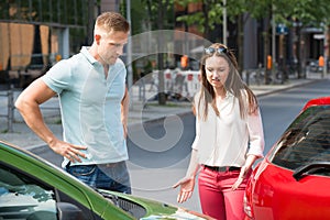 Couple Looking At Car Collision