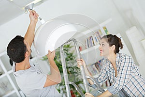 couple looking at celing lighting