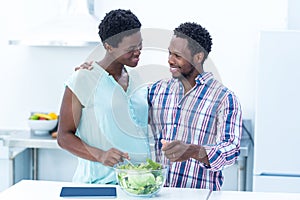 Couple looking at each other while having salad