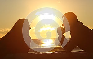 Couple looking each other at sunset