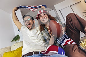 Couple looking excited and happy after their favorite football team scored a touchdown