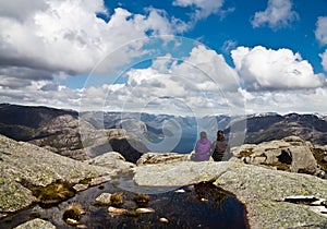 Couple looking at fjord from Kjerag area in Norway