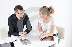 Couple looking at floor plans for new place