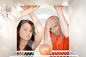 Couple looking in fridge