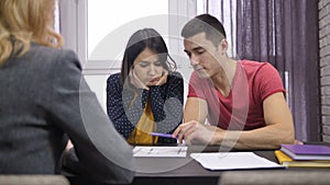 Couple looking at house project with architect