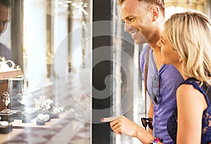 Couple looking at jewelry store window