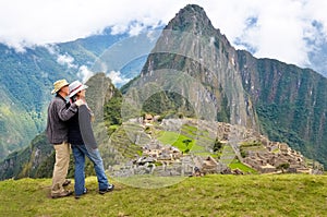 Couple looking at Machu picchu Peru