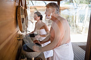 Couple looking at mirror in cottage