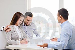 Couple looking at model of their house at office