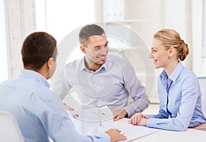 Couple looking at model of their house at office