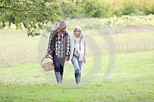 Couple looking for mushrooms on sunny day