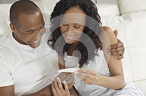 Couple Looking At Pregnancy Test