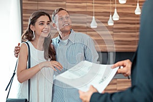 Couple looking at realtor giving them the documents