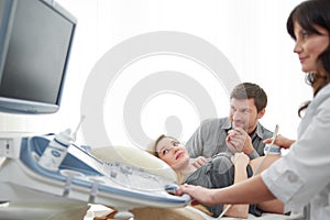 Couple looking at screen on image of baby.