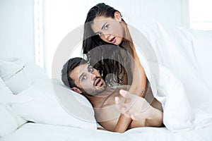 Couple looking shocked while romancing