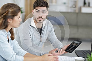 couple looking at their bills in their living room