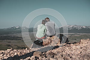Couple looks out over hazy Wyoming mountains