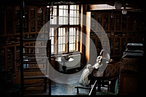 Couple looks out the window in the old library