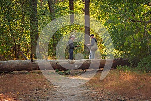 Couple lost in forest. Man and woman with mobile guide in woods. Wanderlust in autumn forest. Looking for direction.