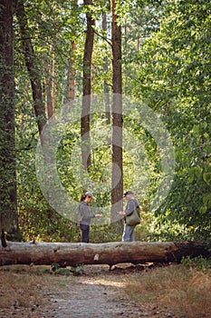 Couple lost in forest. Man and woman with mobile guide in woods. Wanderlust in autumn forest. Looking for direction.