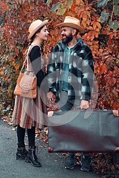 Couple in love in autumn leaves. Adventure, travel, tourism, hike and people concept - smiling couple walking with