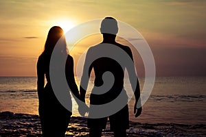 Couple in love back light silhouette on sea