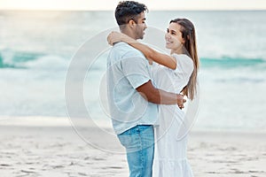 Couple love at beach, look in eyes and hug, with sunset over ocean in nature background or scene. Happy young, man and