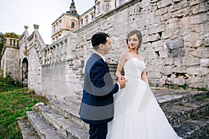 Couple in love. Bride and groom kissing on stairs of old palace