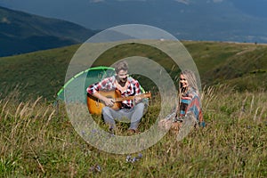 Couple in love camping. Romantic music and happy couple relationships. Romance couple with guitar.