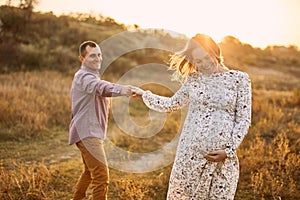 Couple in love caucasian man and woman holding hands outdoors