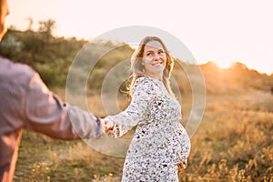 Couple in love caucasian man and woman hugging holding hands kissing outdoors