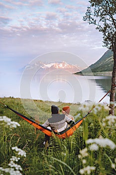 Couple in love chilling in hammock man and woman traveling together summer vacations