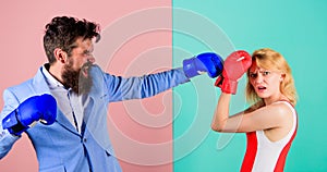 Couple in love competing in boxing. Female and male boxers fighting in gloves. Domination concept. Gender battle. Gender