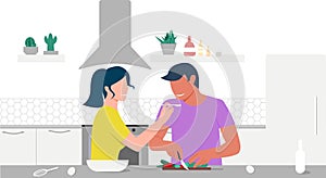 A couple in love cooks in their kitchen. The girl feeds the guy with a spoon. Joint cooking. Stay at home on quarantine