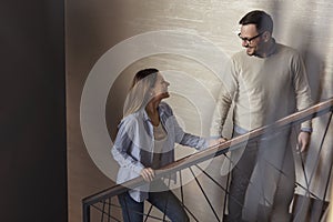 Couple holding hands and walking up the stairs