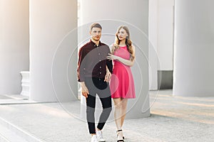 Couple in love, dating in the city outdoors. Romantic couple walking in the city holding hands, February 14