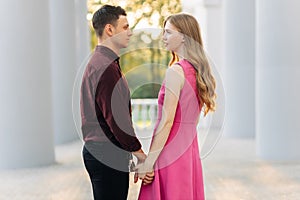 Couple in love, dating in the city outdoors. Romantic couple walking in the city holding hands, February 14