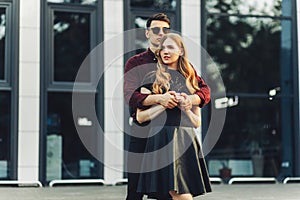 Couple in love, dating in the city outdoors. Romantic couple walking in the city holding hands, February 14