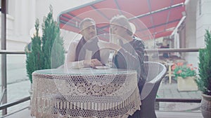 Couple in love drinking coffee on romantic date in cafe outdoors