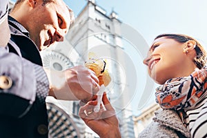 A couple in love eat ice-cream during their Italian voyage